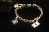 Cartier Spartacus Bettelarmband mit Charms Love CC Kreuz Würfel 750er Gold 