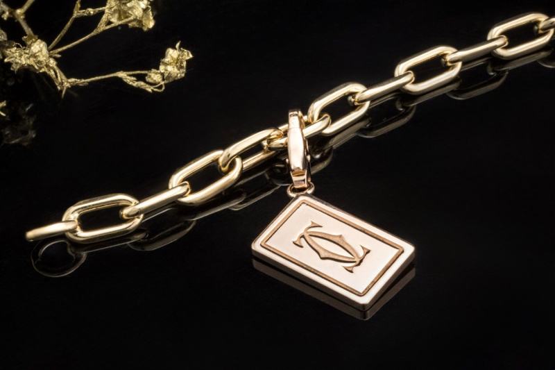 Cartier Spartacus Bettelarmband mit Charms Love CC Kreuz Würfel 750er Gold 